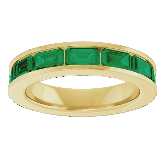 Gold ring with emerald green gemstones on a white background