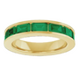 Gold ring with emerald green gemstones on a white background