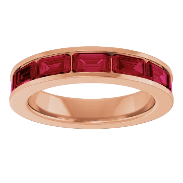 Rose gold ring with red gemstones on a white background