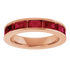 Rose gold ring with red gemstones on a white background