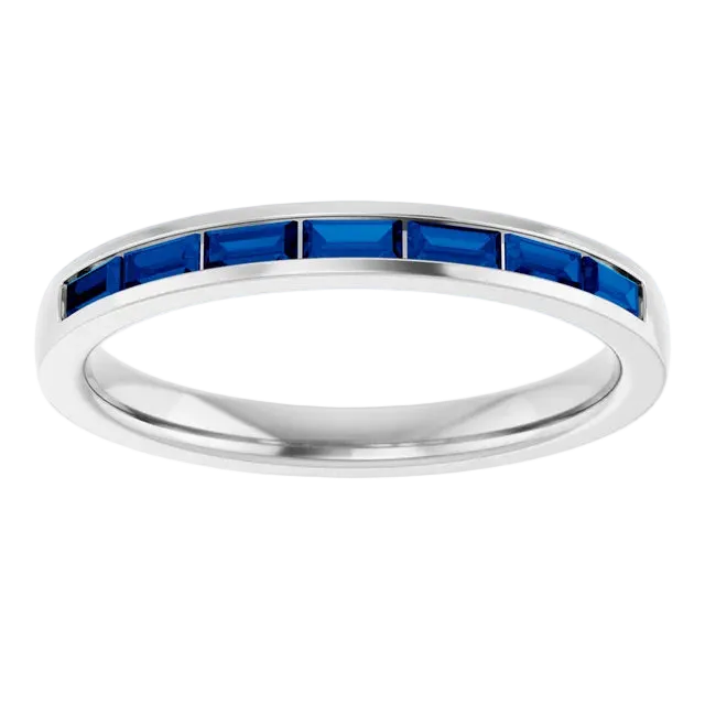 white gold ring with blue gemstones on a white background, an anniversary band