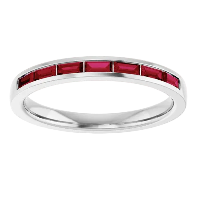 Silver ring with red gemstones on a white background